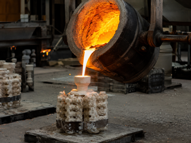 Molten metal pouring into an investment casting ceramic shell mold